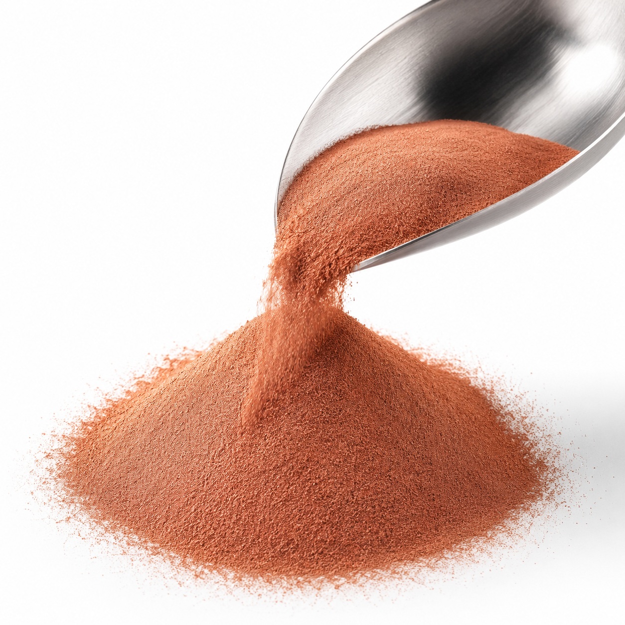Ultrafine copper powder poured from a metal spoon